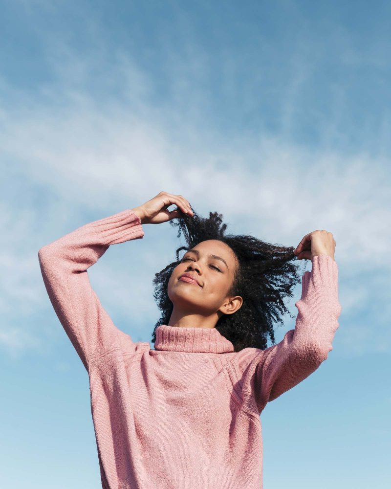 portrait-of-young-woman-against-sky-touching-her-h-8ZNBVGY.jpg